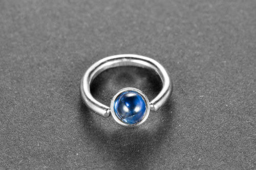 Piercingring with a sapphire-cabochon